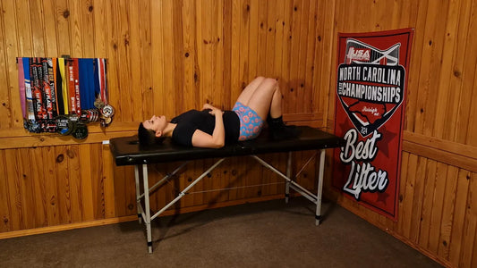 Close view of person lying on a bench with hands on belly demonstrating belly breathing